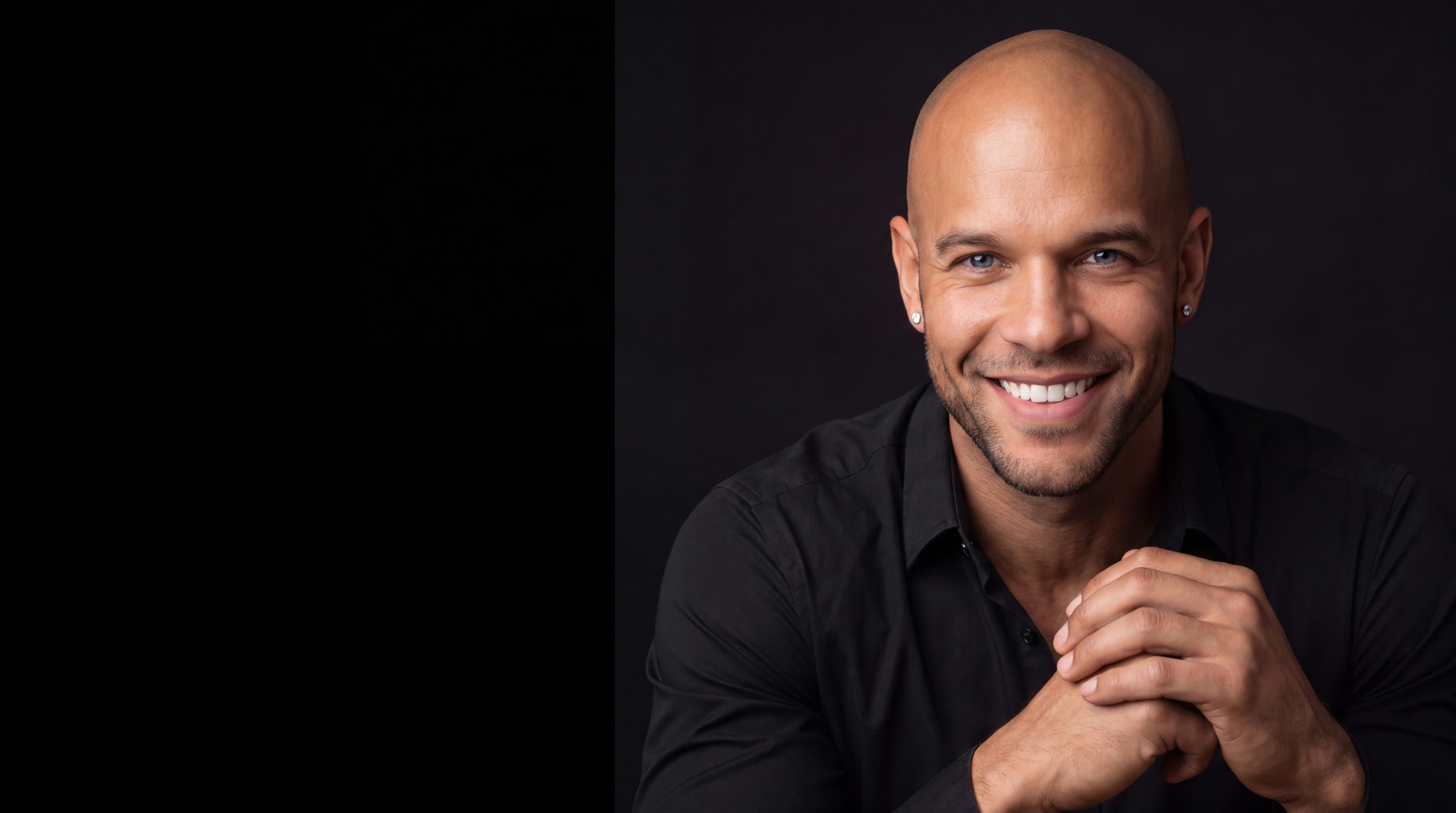 JT Taylor MS, MBA, host of the Notebook of a COO business operations podcast, smiling with his hands clasped